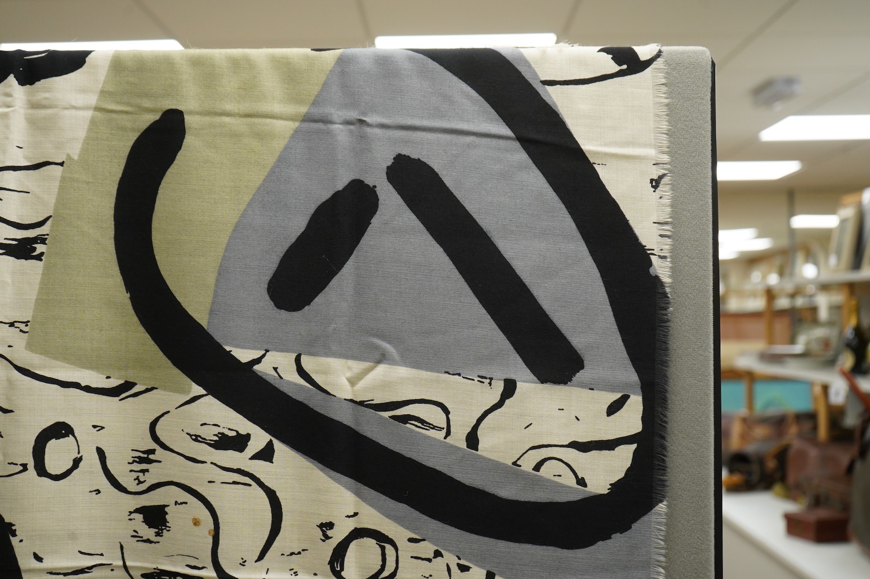 A large wool scarf designed with large faces by Brian Bolger, (RCA 1983) and The Cloth.100cm wide x 140cm. Condition - good